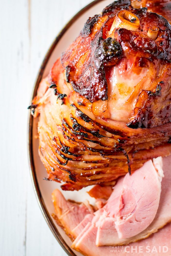 Top down view of ham on platter with some slices removed