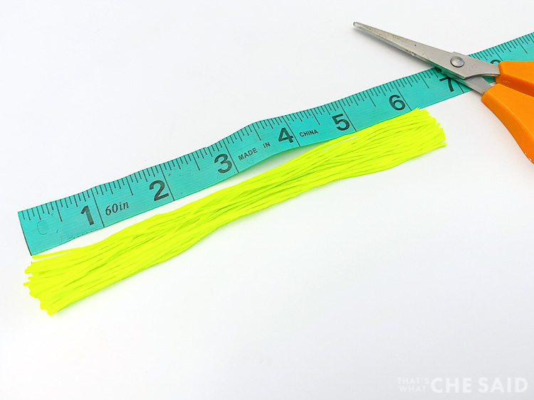 Measuring tape with embroidery thread cut to 7 inch lengths