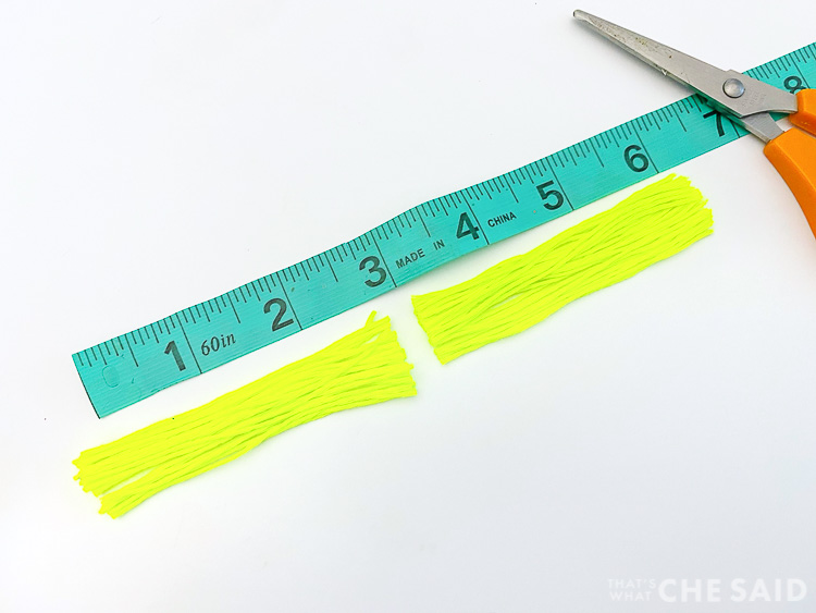 Measuring tape with embroidery thread cut in half