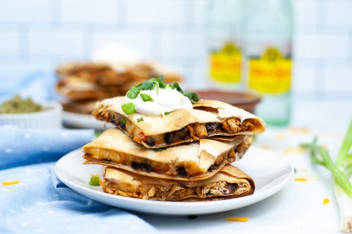 Sheet Pan Chicken Quesadillas cut and stacked on a plate