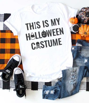 White shirt on plaid runner with jeans and t-shirt and Halloween saying on T-shirt