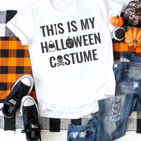 White shirt on plaid runner with jeans and t-shirt and Halloween saying on T-shirt