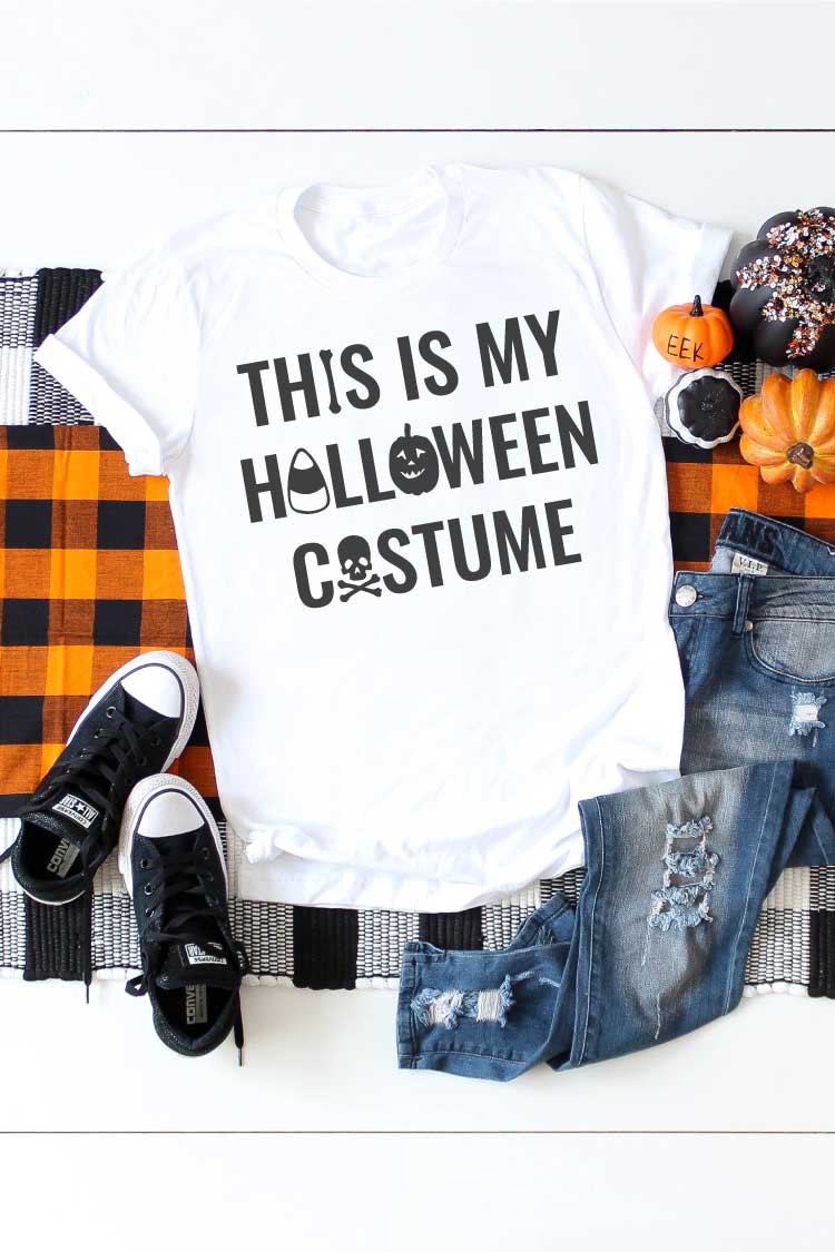 White shirt on plaid runner with jeans and t-shirt and Halloween saying on T-shirt