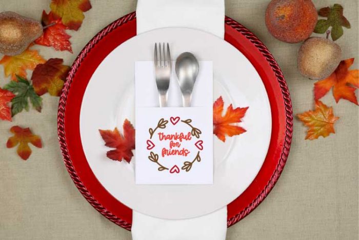 Fall place setting with paper silverware holder with thankful for friends svg design on it