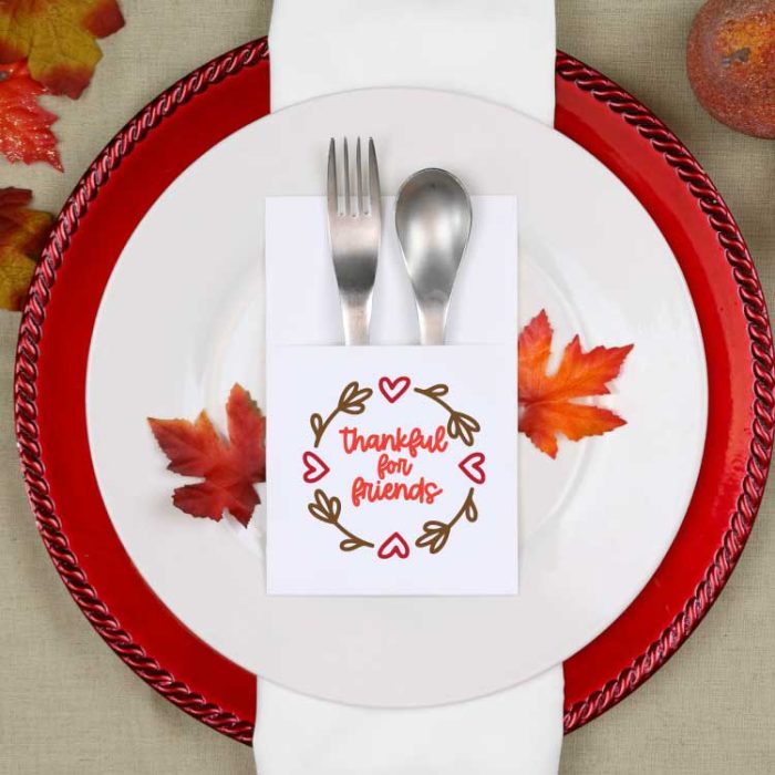 Fall place setting with paper silverware holder with friendsgiving svg design on it