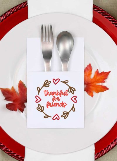 Fall place setting with paper silverware holder with friendsgiving svg design on it vertical orientation