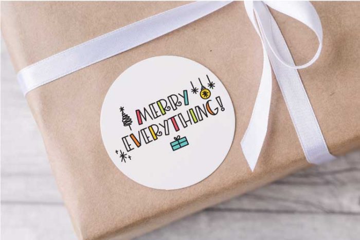 Brown paper package with Merry Everything Sticker in Corner