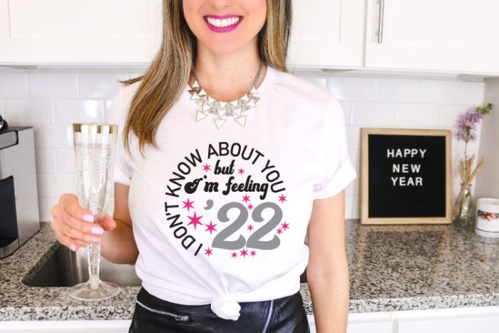 Woman holding champagne with 2022 saying on T-Shirt - Horizontal