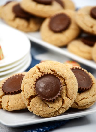 Peanut butter cookies with peanut butter cups candy pressed to the center