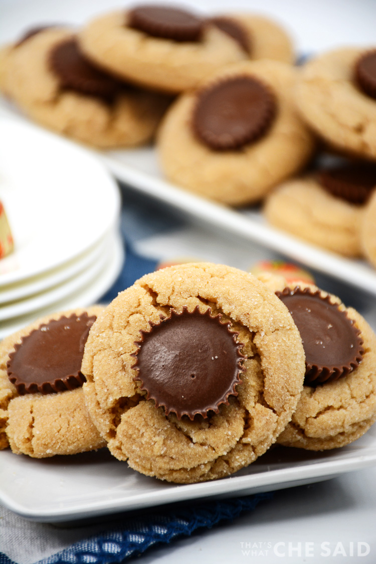 Peanut butter cookies with peanut butter cups candy pressed to the center