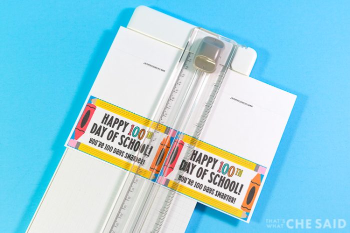 Paper cutter cutting 100 days of school treat bag toppers down to size