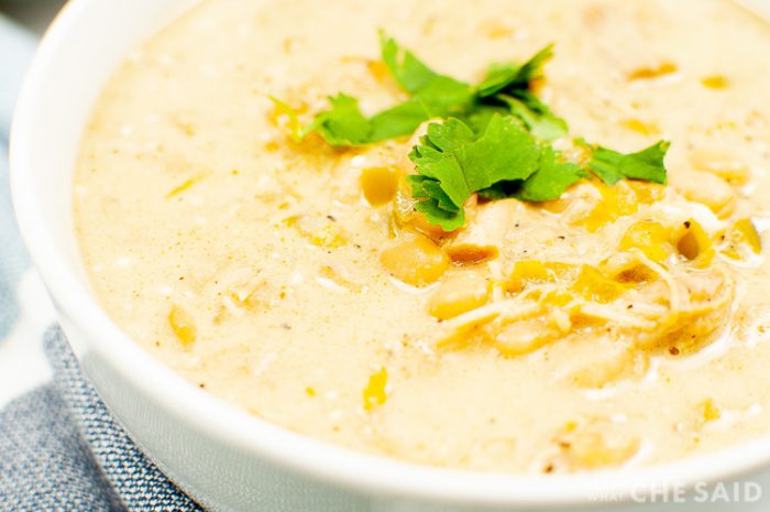 White Chicken Chili garnished with cilantro in a white bowl