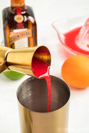 Measuring liquor in Jigger and shaker for Blood Orange Margarita