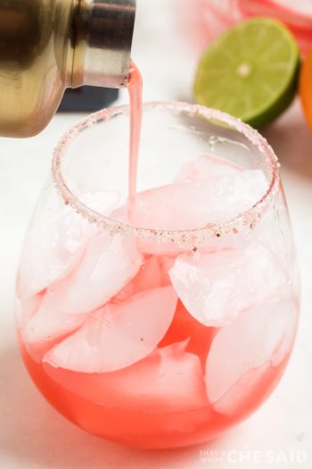 Pouring Blood Orange Margaritas over ice into glass