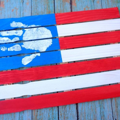 Flag made of paint sticks and painted like an american flag with hand print as the stars