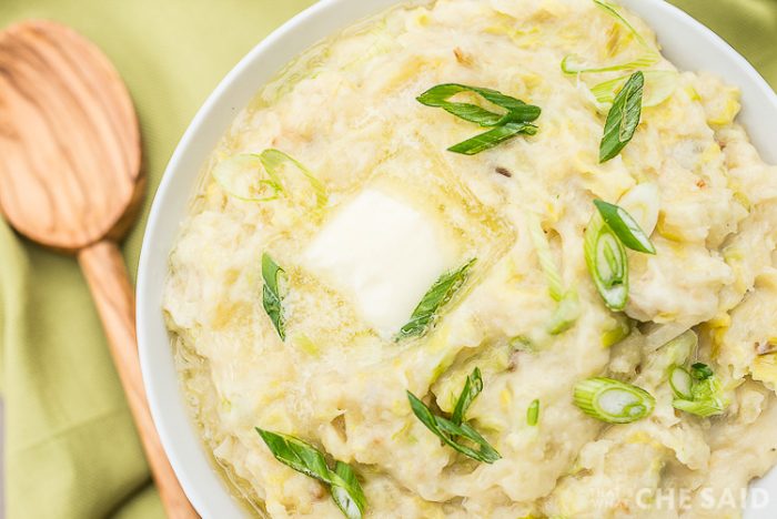 Horizontal close up of Irish Colcannon potatoes with scallions and melted butter