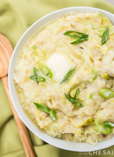 Instant Pot Irish Colcannon in a bowl with green napkin and wooden spoon - featured image