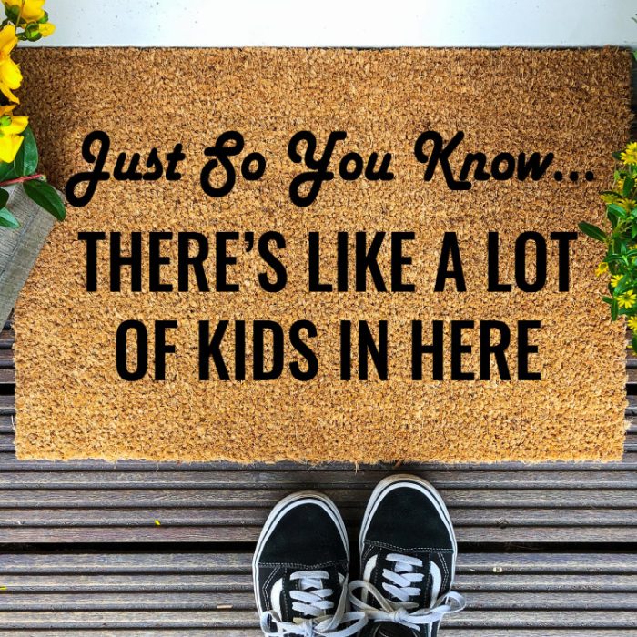 Coir Doormat with Black Tennis shoes and yellow flowers and funny saying in paint