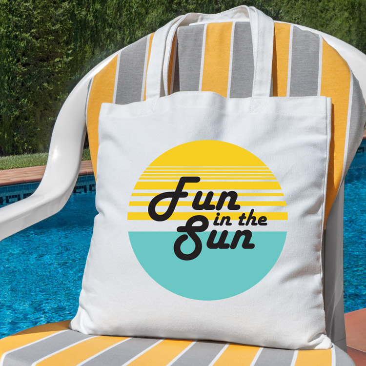 beach chair with beach bag with fun in the sun design and pool in the background - square