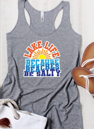 Grey tank top with bag, sunglasses and sandals. Lake Life SVG in iron on vinyl Square format