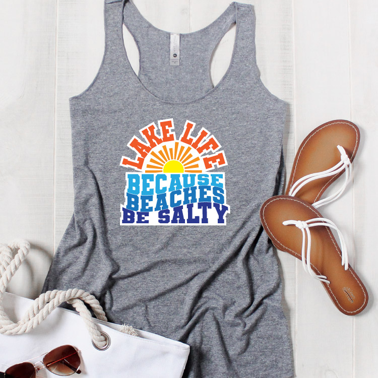 Grey tank top with bag, sunglasses and sandals. Lake Life SVG in iron on vinyl Square format