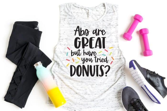 work out tank with donut saying and weights and shoes and water bottle.