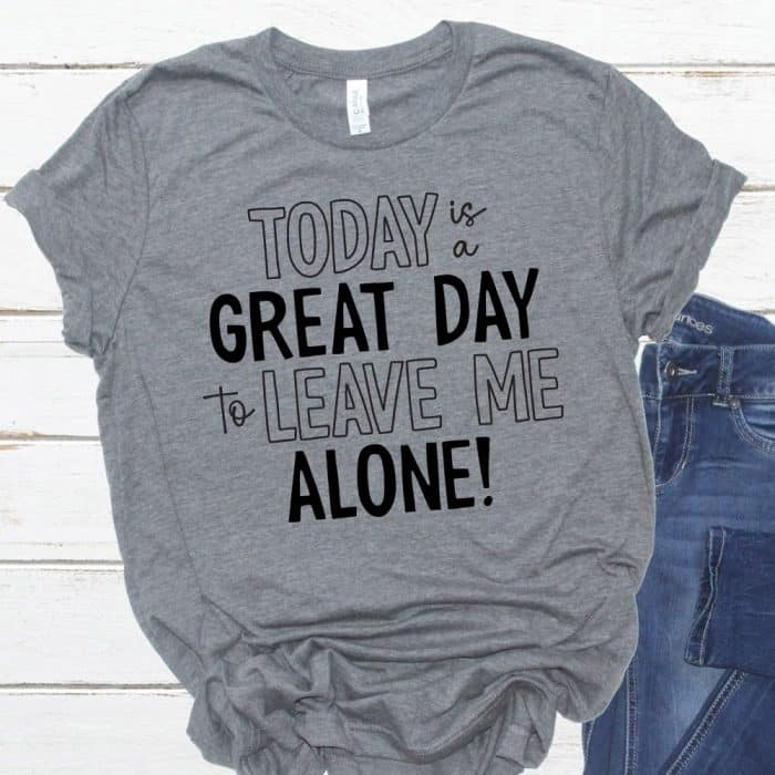 Square crop of a tshirt sandals and jeans flatlay with "today is a great day to leave me alone" on the t-shirt