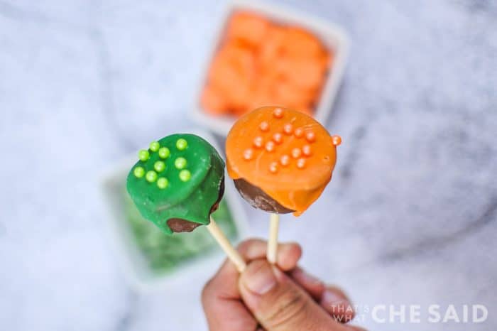 Close up of "bubbles" on top of Cauldron Cake Pops with Orange and Green icing