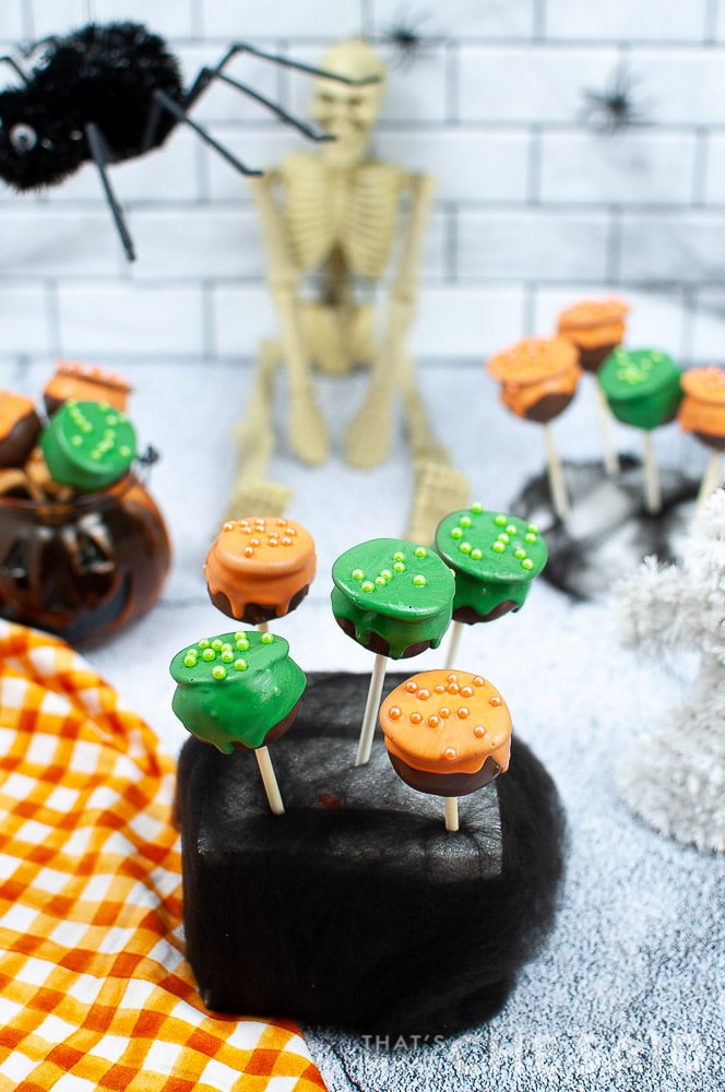 Cauldron Cake pops with Halloween Decor in background