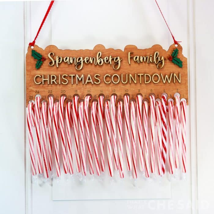 Family name candy cane advent calendar with red and white candy canes and stained board