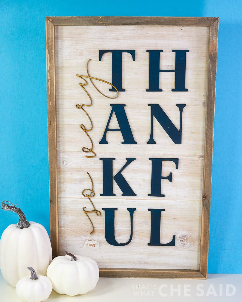 So very thankful sign on blue background with white pumpkins