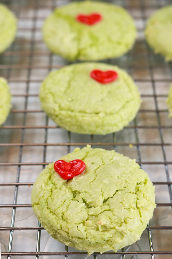 Grinch Cookies on a wire cooking rack, close up.