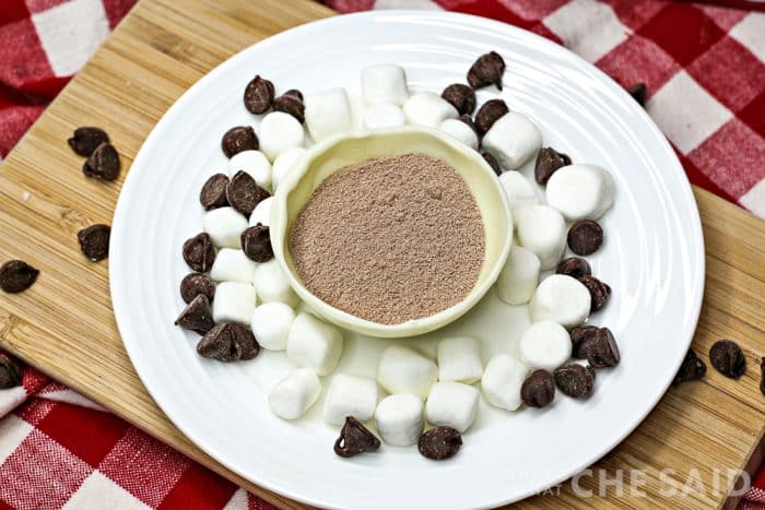 Half shell of snowman hot chocolate bomb filled with hot chocolate mix