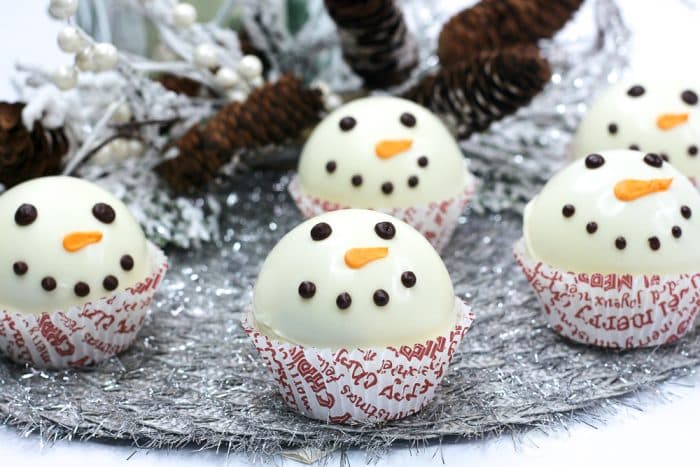 snowman hot cocoa bomb in a cupcake liners on platter