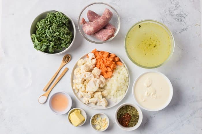 Sausage Kale Ingredients in bowls on marble background