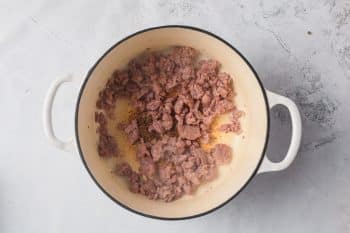 browned sausage in cast iron dutch oven