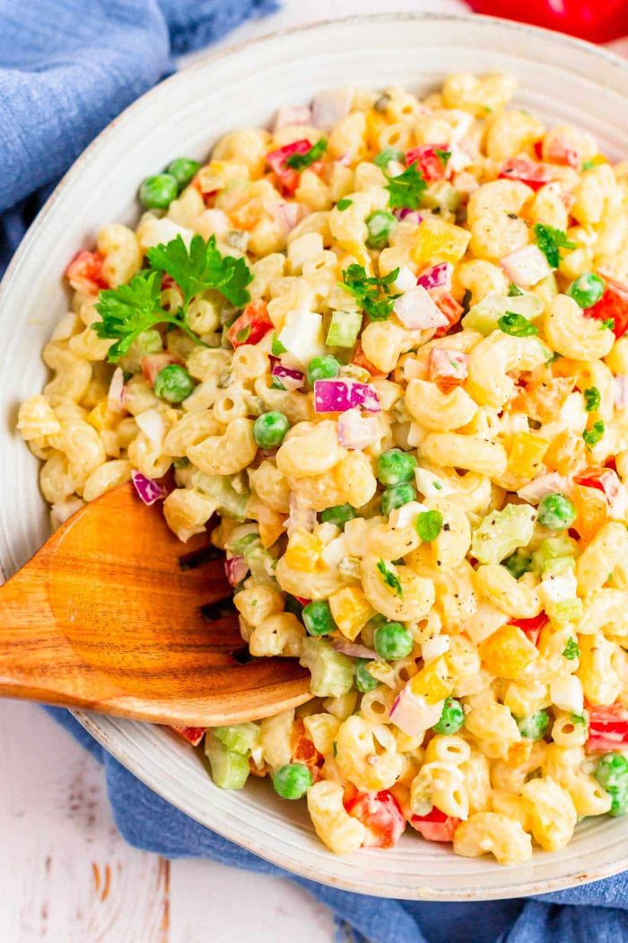 Mararoni Salad in white bowl with wooden spoon