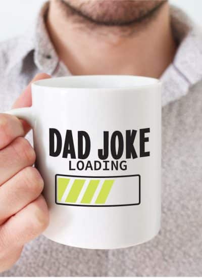 Man holding coffee mug wtih words that read "dad joke loading" with a loading bar