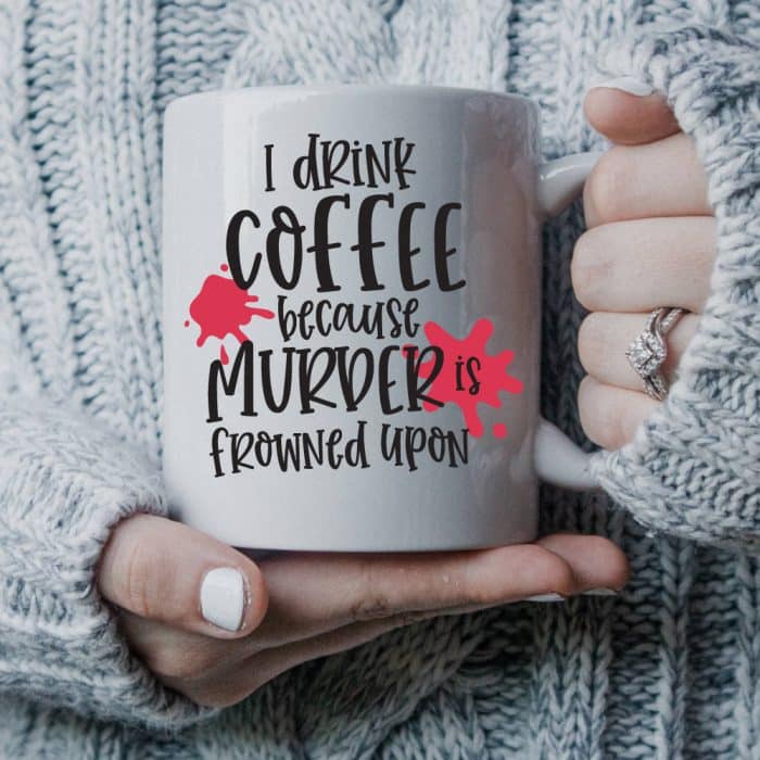 Woman in sweater holding coffee mug with murder svg
