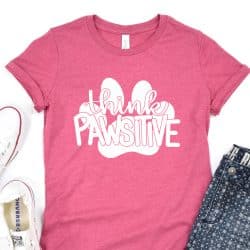 Pink t-shirt with "think Pawsitive" and Paw Print design