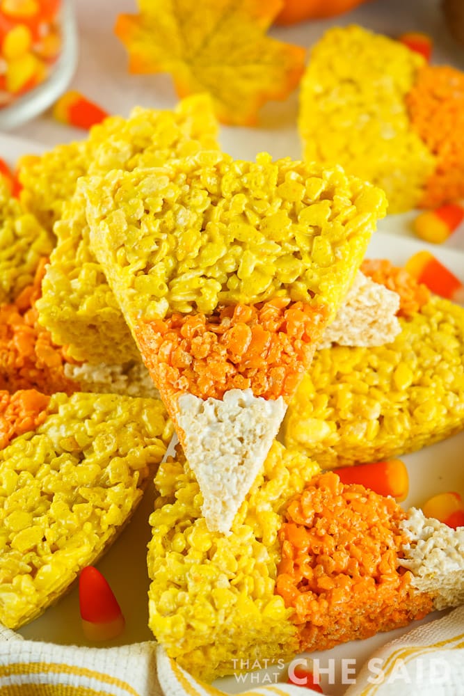Candy Corn Halloween Rice Krispie Treats stacked on a platter