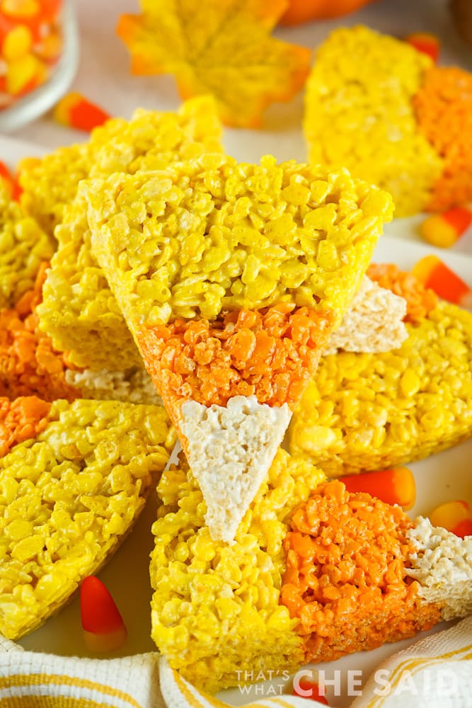 Candy Corn Halloween Rice Krispie Treats stacked on a platter