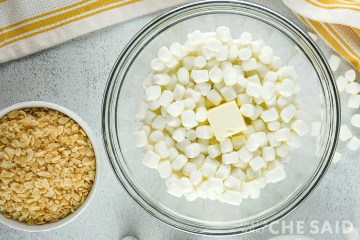 Bowl with mini-marshmallows and butter with crispy rice cereal on the side