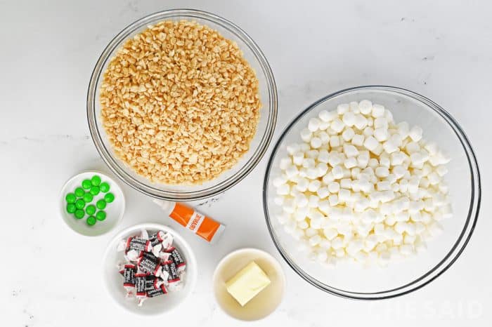 Ingredients for pumpkin shaped rice krispie treats on white table top