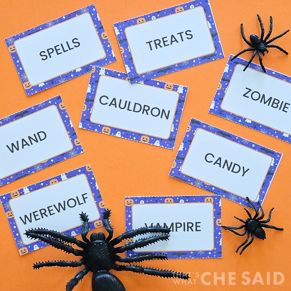 Halloween Printable Charade Game Cards on orange background with spiders in square format