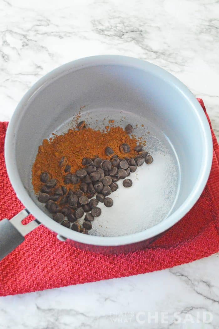 Sugar, cocoa powder and chocolate chips in a saucepan
