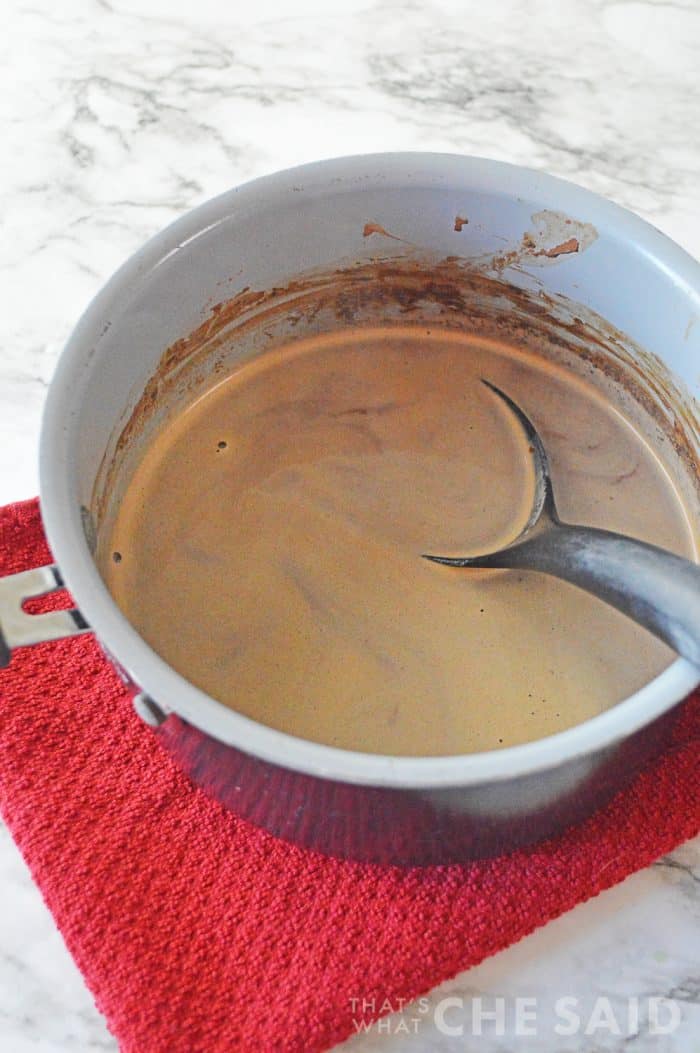 melted hot chocolate in a sauce pan with a spoon