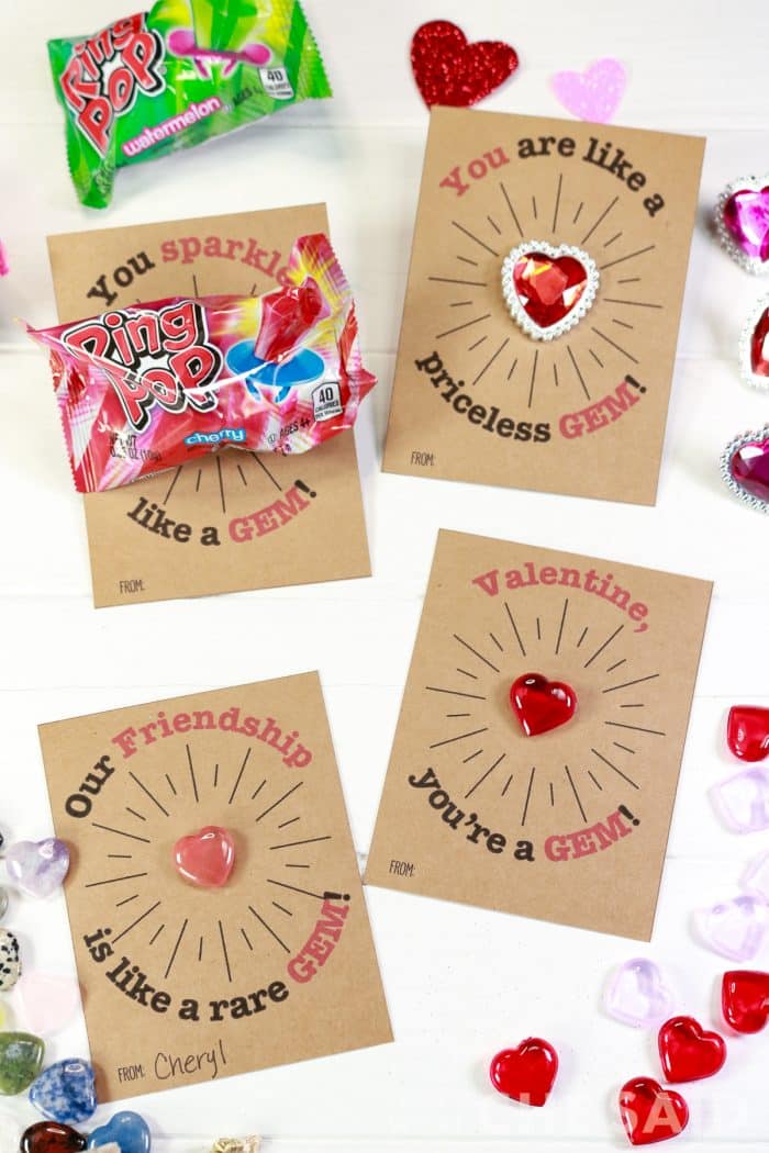 Vertical photo of 4 gem valentines each with a different trinket or treat.