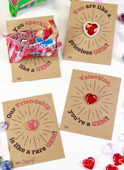 Square photo of 4 gem valentines each with a different trinket or treat.