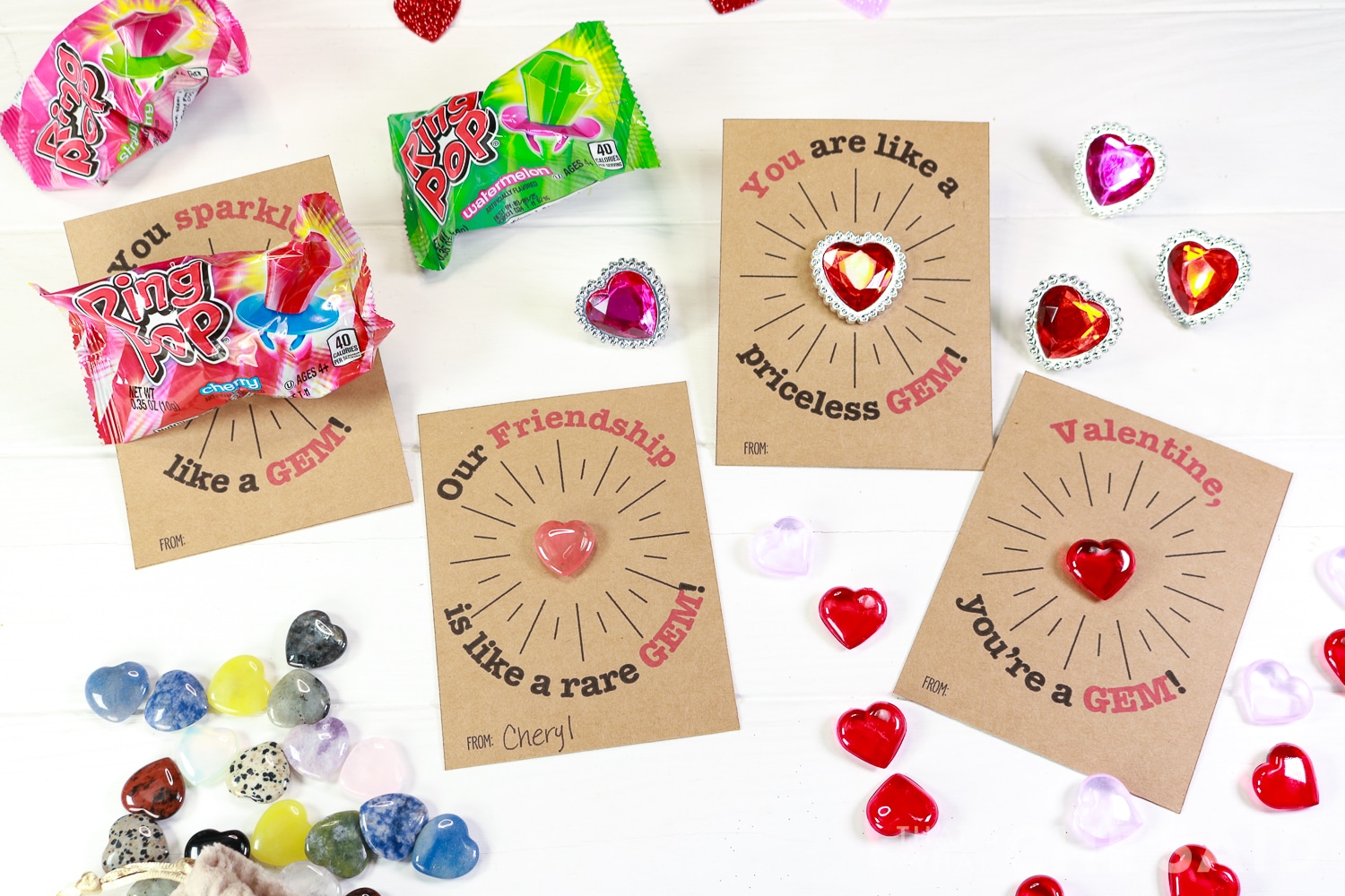 Horizontal photo of 4 gem valentines each with a different trinket or treat.